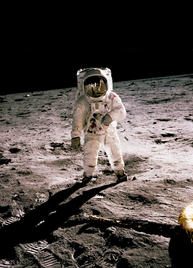 An astronomer who has landed on the moon wearing a white suit.